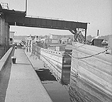 Tug pulling barges through Lock 11