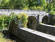 Looking northeast at the arches which support the towpath