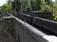 The narrow channel which feeds water to the canal, looking southeast