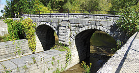 Looking northwest at the arches which support the towpath