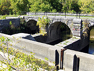 Looking northwest at the arches which support the towpath