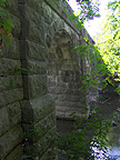 Looking west at the arches of the towpath from the stream level